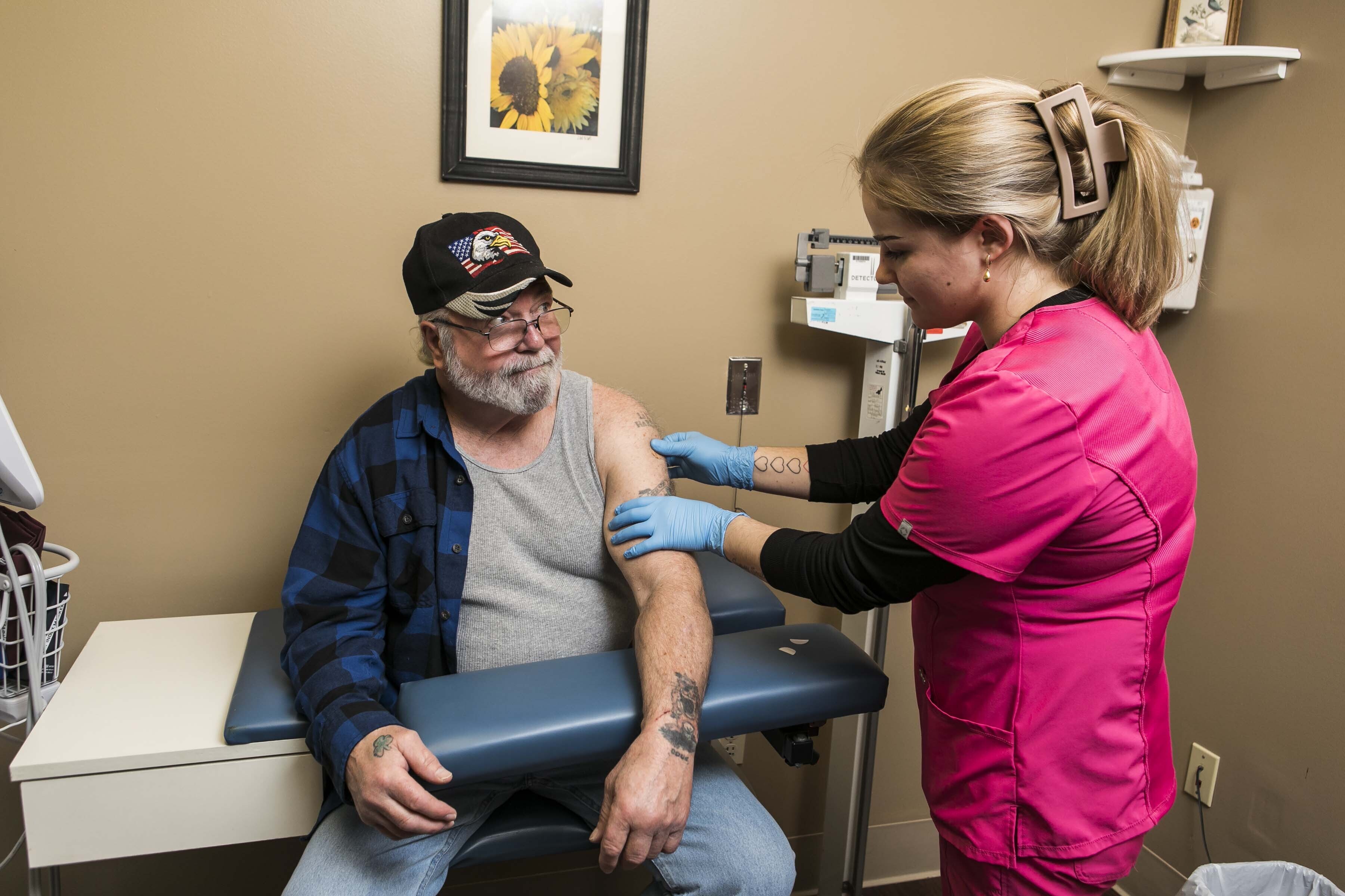 Doctor wearing gloves interacts with patient