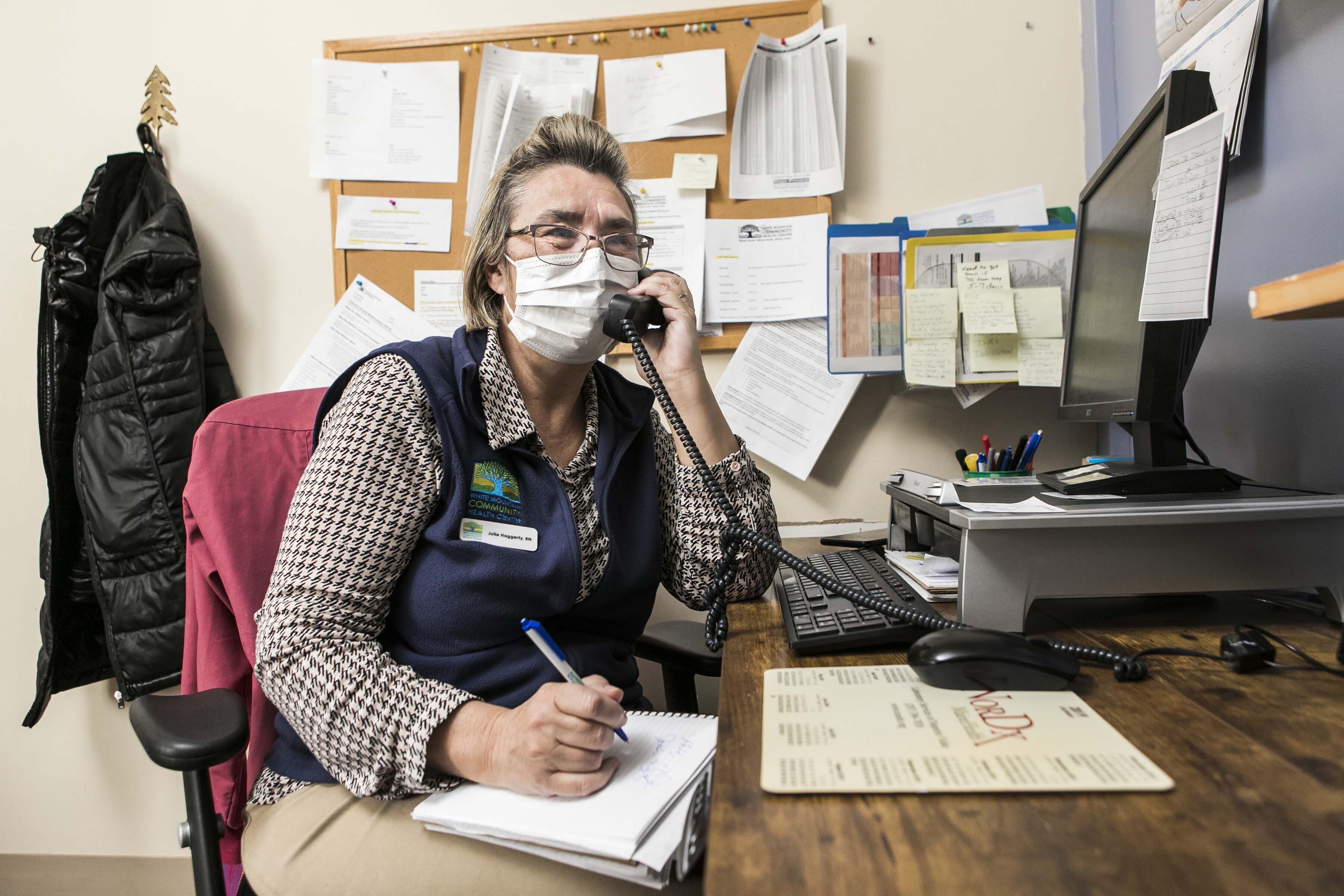 Receptionist taking notes during phone call