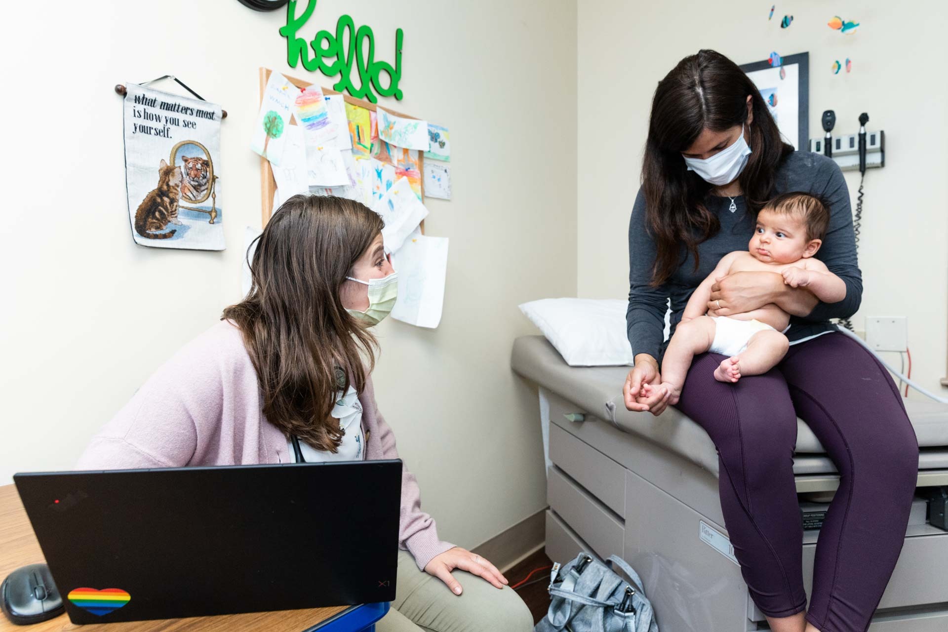 Baby making face at provider while parent holds them