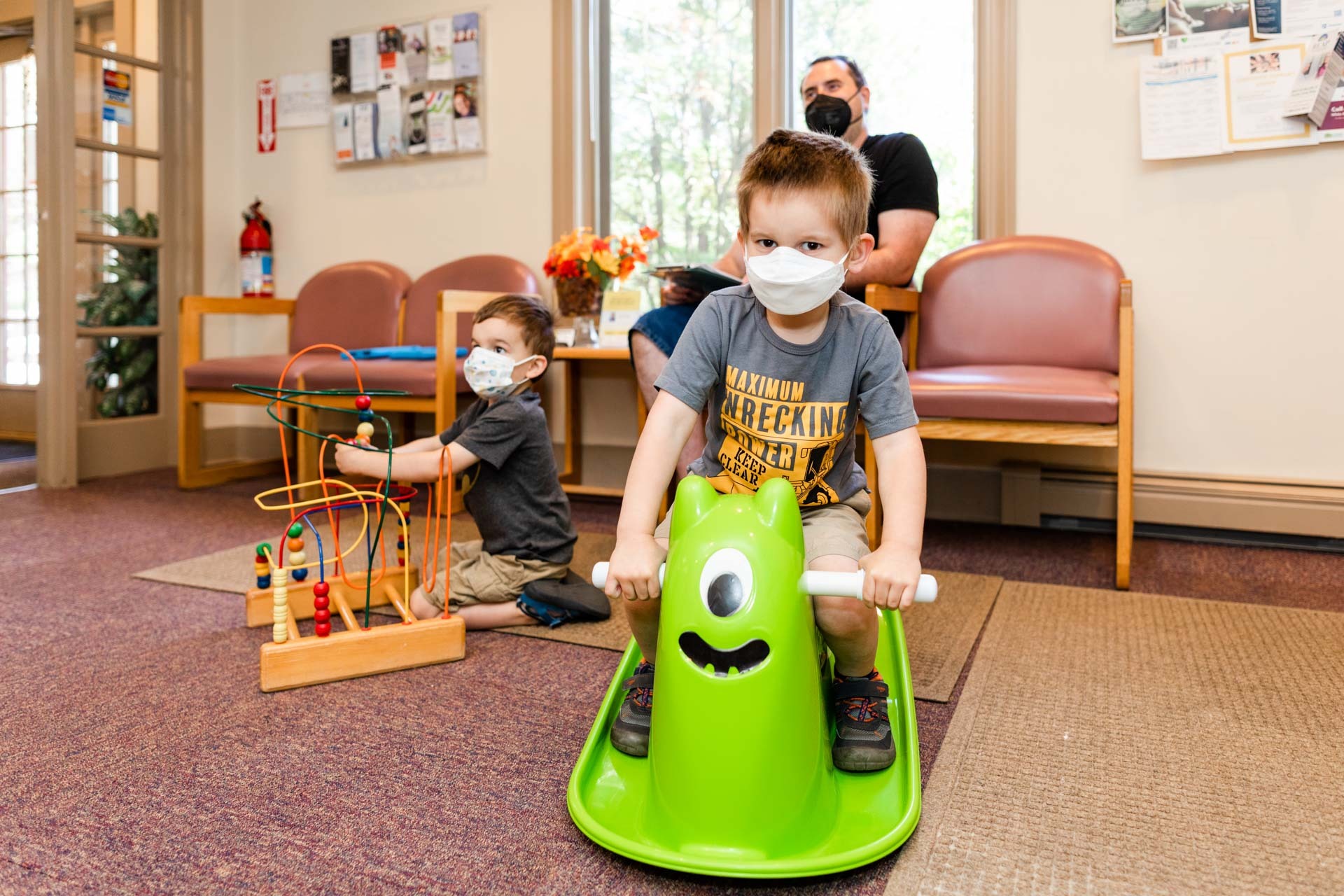 Family plays with toys in the waiting area