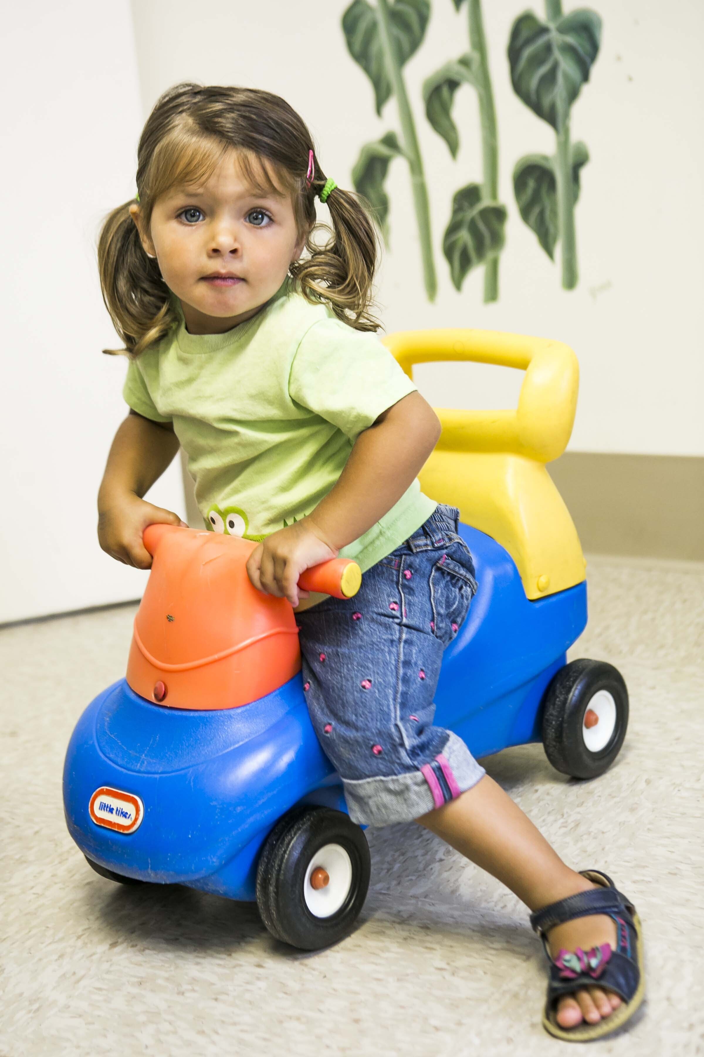 Child playing with toy vehicle