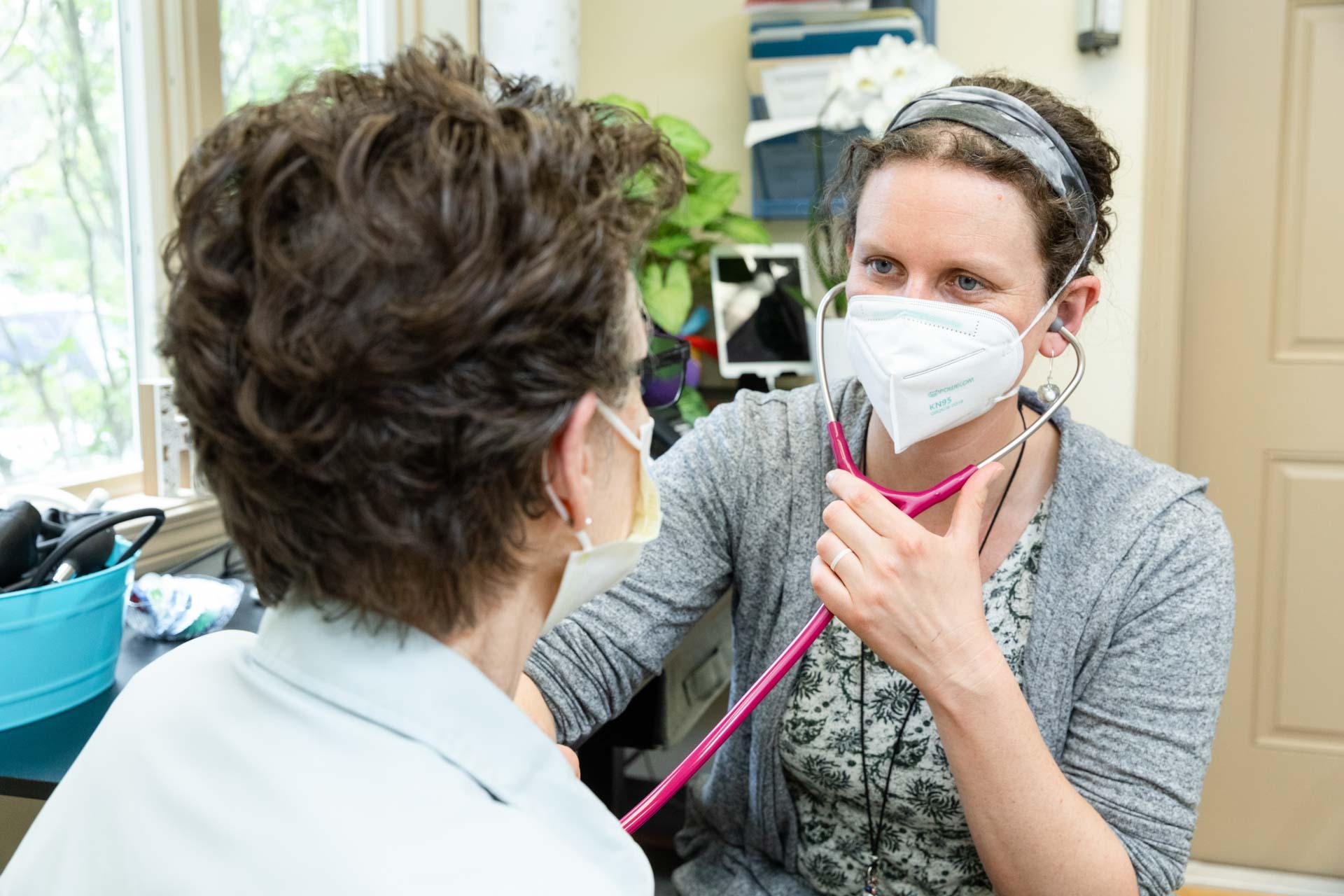 Practitioner listens to patients chest with stethoscope