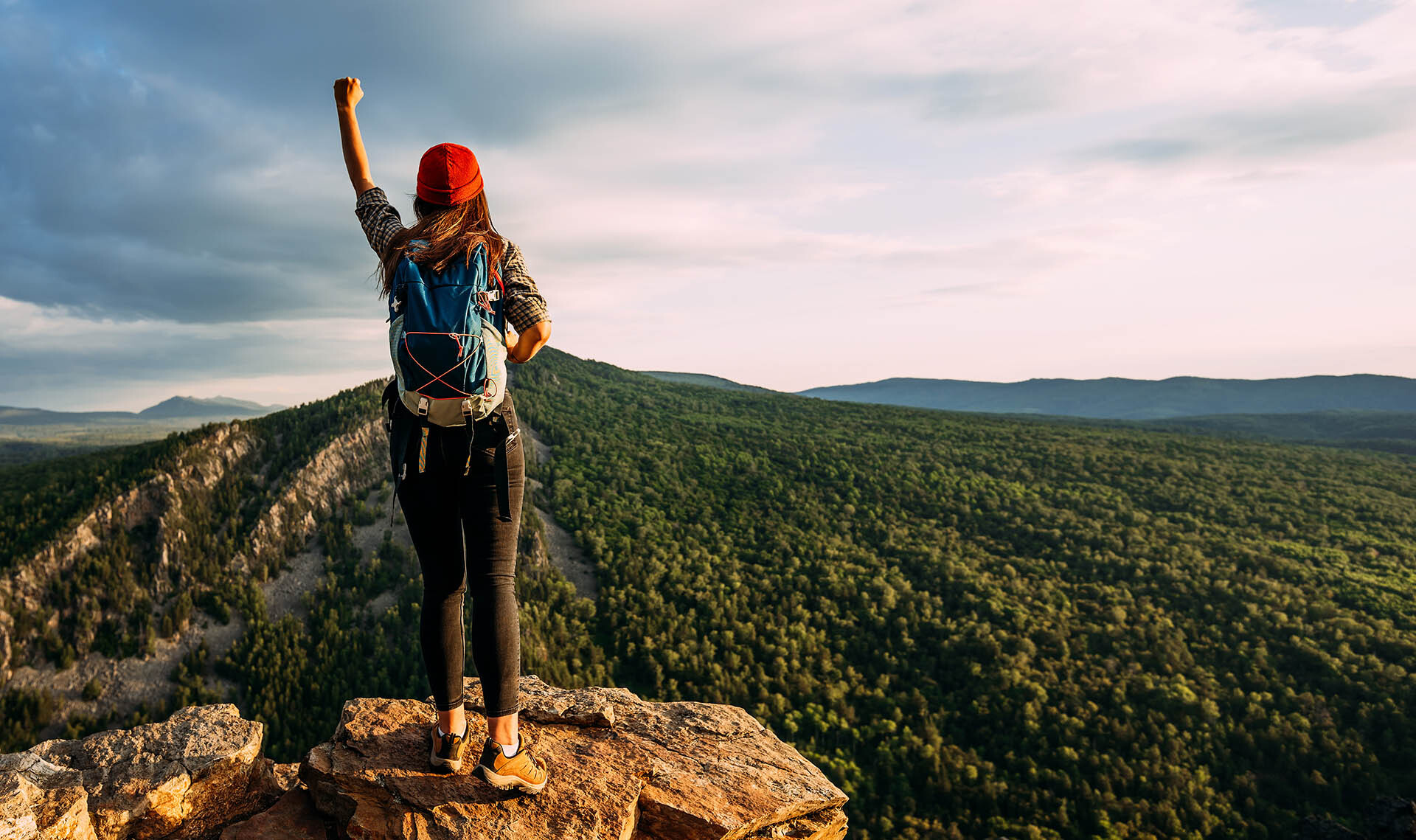 Triumphant at the edge of a cliff looking at beautiful view